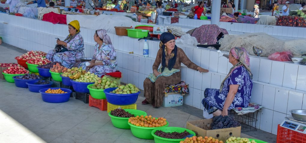 Uzbek and Tajik women selling their fruit at the market bazaar in Bukhara, Uzbekistan. Many of these varieties of fruits have been sold in markets here for thousands of years. The prehistoric origins of these fruits and their historical dispersals are laid out in Fruit from the Sands.