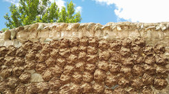 Dung mixed from goats, sheep and yaks are commonly utilized fuel by Tibetan household. In this photo, dung drying on the wall under the scorching sun in central Tibet.