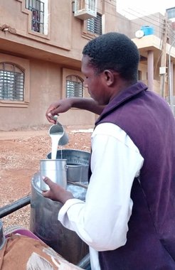 A man selling milk in a town north of Khartoum, Sudan.