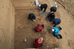 Archaeologists excavating the well-preserved surfaceat the Xiamabei site, northern China, showing stone tools, fossils, ochre and red pigments.