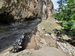 View of the rock shelter site Obishir-5 during fieldwork in 2021.