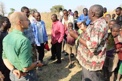 Project members and area Chief Imbeywe discuss the archaeological research at a community meeting in Salumano village.